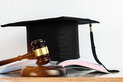 A gavel and law books on a desk, representing the legal profession.
